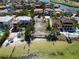 Aerial view of waterfront property with neighboring houses and lush landscaping at 1013 Symphony Isles Blvd, Apollo Beach, FL 33572
