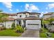 Two-story home with a white and brown exterior, two-car garage, and landscaped yard at 1039 Seagrape Dr, Ruskin, FL 33570