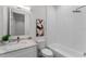 Bright bathroom with a marble countertop, single sink, soaking tub with white herringbone tile at 5530 N 9Th St # 3, Tampa, FL 33604