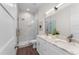 Modern bathroom with dual sinks, granite countertops, and a glass-enclosed shower at 5530 N 9Th St # 3, Tampa, FL 33604