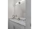 Bathroom vanity with marble countertop, silver faucet and hardware, and modern mirror at 5530 N 9Th St # 3, Tampa, FL 33604