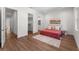 Well-lit bedroom featuring wood-look floors, an area rug, and closet entrance at 5530 N 9Th St # 3, Tampa, FL 33604