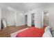 Bedroom featuring wood-look floors, walk-in closet, and a shower at 5530 N 9Th St # 3, Tampa, FL 33604