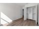 Bedroom with wood floors and open closet featuring built-in shelving at 5530 N 9Th St # 3, Tampa, FL 33604