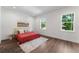 Well-lit bedroom with hardwood floors, two large windows, and a cozy rug at 5530 N 9Th St # 3, Tampa, FL 33604