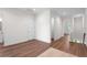 Bright hallway featuring hardwood floors, white walls, and access to multiple rooms at 5530 N 9Th St # 3, Tampa, FL 33604
