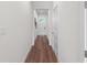 Hallway featuring wood floors, white trim, and doors leading to various rooms at 5530 N 9Th St # 3, Tampa, FL 33604