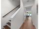Staircase with wood floors, leading into a large living area with hardwood floors at 5530 N 9Th St # 3, Tampa, FL 33604