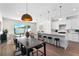 Open concept kitchen with white cabinets, island seating, and adjoins dining and living areas at 5530 N 9Th St # 3, Tampa, FL 33604