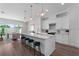 Bright, modern kitchen featuring white cabinetry, a marble island, and pendant lighting at 5530 N 9Th St # 3, Tampa, FL 33604