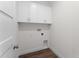 Functional laundry room with white cabinets, washer/dryer hookups, and wood-look flooring at 5530 N 9Th St # 3, Tampa, FL 33604