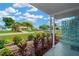 View from the front porch of a lush front yard and neighboring homes on a sunny day at 6027 Flora Ter, Apollo Beach, FL 33572