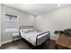 Bedroom with a metal bed frame and a small white nightstand at 1039 Seagrape Dr, Ruskin, FL 33570