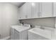 Laundry room with white cabinets, a washer, and a dryer at 1039 Seagrape Dr, Ruskin, FL 33570