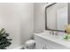 Small half bathroom with white vanity and gray framed mirror at 1039 Seagrape Dr, Ruskin, FL 33570