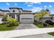 Two-story home with tile roof, attached garage, and landscaping at 1039 Seagrape Dr, Ruskin, FL 33570