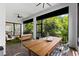 Screened patio with seating area and dining table, overlooking lush greenery at 1039 Seagrape Dr, Ruskin, FL 33570