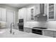 Modern kitchen with stainless steel appliances and white cabinets at 1039 Seagrape Dr, Ruskin, FL 33570