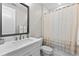 Bathroom with white cabinets, a bathtub, and a shower at 1039 Seagrape Dr, Ruskin, FL 33570