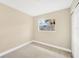 Simple bedroom with neutral walls, carpet, and a window at 6027 Flora Ter, Apollo Beach, FL 33572