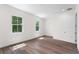 Bright bedroom with hardwood floors and two large windows at 5530 N 9Th St # 3, Tampa, FL 33604