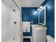 Modern bathroom with white subway tile shower and blue walls at 34868 Prospect Rd, Dade City, FL 33525