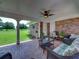Brick patio with wicker furniture and ceiling fan, overlooking a grassy yard at 34868 Prospect Rd, Dade City, FL 33525