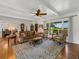 Bright living room with hardwood floors, comfortable seating, and large windows at 34868 Prospect Rd, Dade City, FL 33525