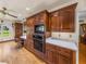 Kitchen with dark wood cabinets, built in appliances, and hardwood floors at 34868 Prospect Rd, Dade City, FL 33525