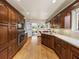 Large kitchen with wood cabinets, island, and hardwood floors at 34868 Prospect Rd, Dade City, FL 33525