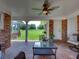 Brick patio with seating area, ceiling fan, and a view of the pasture at 34868 Prospect Rd, Dade City, FL 33525