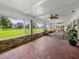 Sunroom with brick walls, wood flooring, and large windows overlooking a field at 34868 Prospect Rd, Dade City, FL 33525