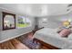 Bedroom with hardwood floors, large windows, and a comfortable bed at 34868 Prospect Rd, Dade City, FL 33525