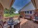 Brick patio with table and chairs and a view of the property at 34868 Prospect Rd, Dade City, FL 33525
