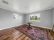 Spacious bedroom with hardwood floors, large windows, and area rug at 34868 Prospect Rd, Dade City, FL 33525