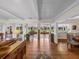 Open living space with hardwood floors, exposed beams and views to the backyard at 34868 Prospect Rd, Dade City, FL 33525