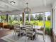 Sunroom dining area features a rustic table and chairs with sunroom views at 34868 Prospect Rd, Dade City, FL 33525