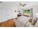 Comfortable bedroom with hardwood floors, built-in closet and ceiling fan at 34868 Prospect Rd, Dade City, FL 33525