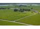 Aerial view showcasing a house on a large lot with surrounding fields at 34868 Prospect Rd, Dade City, FL 33525