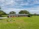 Ranch-style home on a large lot with lush green grass at 34868 Prospect Rd, Dade City, FL 33525