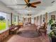 Sunroom with brick walls, wood flooring, and large windows at 34868 Prospect Rd, Dade City, FL 33525