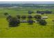 House nestled on a sprawling green landscape, with a barn nearby at 34868 Prospect Rd, Dade City, FL 33525