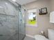 Spa-like bathroom with a large walk-in shower and marble tile at 34868 Prospect Rd, Dade City, FL 33525