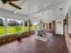 Charming dining area with a rustic table and chairs,sunroom views at 34868 Prospect Rd, Dade City, FL 33525