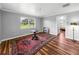 Bright bedroom with hardwood floors, large windows, and area rug at 34868 Prospect Rd, Dade City, FL 33525