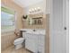 Clean bathroom with single vanity, toilet, and a shower at 34868 Prospect Rd, Dade City, FL 33525