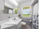 Bathroom with gray tile, a shower/tub combo, and a window with a view at 34868 Prospect Rd, Dade City, FL 33525
