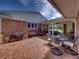 Brick patio with grill and table and chairs, next to a brick house at 34868 Prospect Rd, Dade City, FL 33525