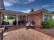 Brick patio with table and chairs, next to a brick house at 34868 Prospect Rd, Dade City, FL 33525