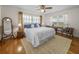 Spacious bedroom with wood floors, a ceiling fan, and a view of the pasture at 34868 Prospect Rd, Dade City, FL 33525